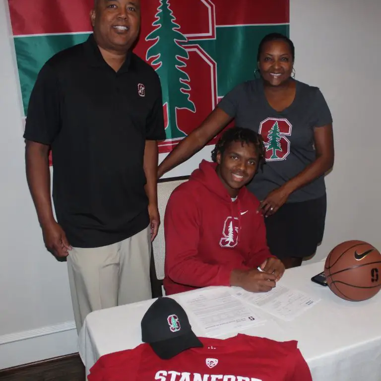 Harrison Ingram with his parents as he signed with Standford College