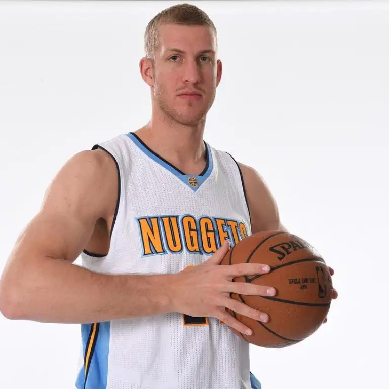 Mason Plumlee posing in Denver Nuggets Jersey