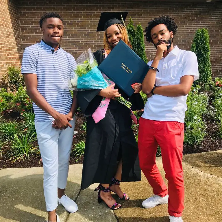 Isaiah with his brother and sister during his sister's graduation