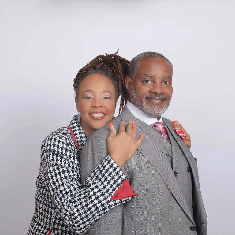 Jordan Walsh's parents posing for a picture in a studio.