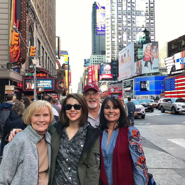 Morgan Ortagu taking picture with her parents and grandmother in New York