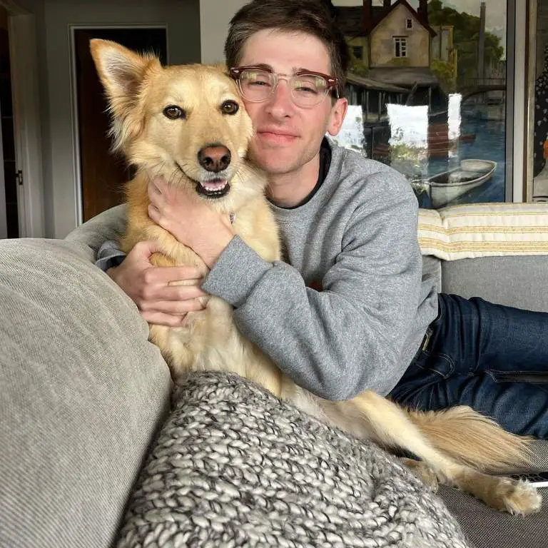 Noah Robbins with his pet dog at his home.