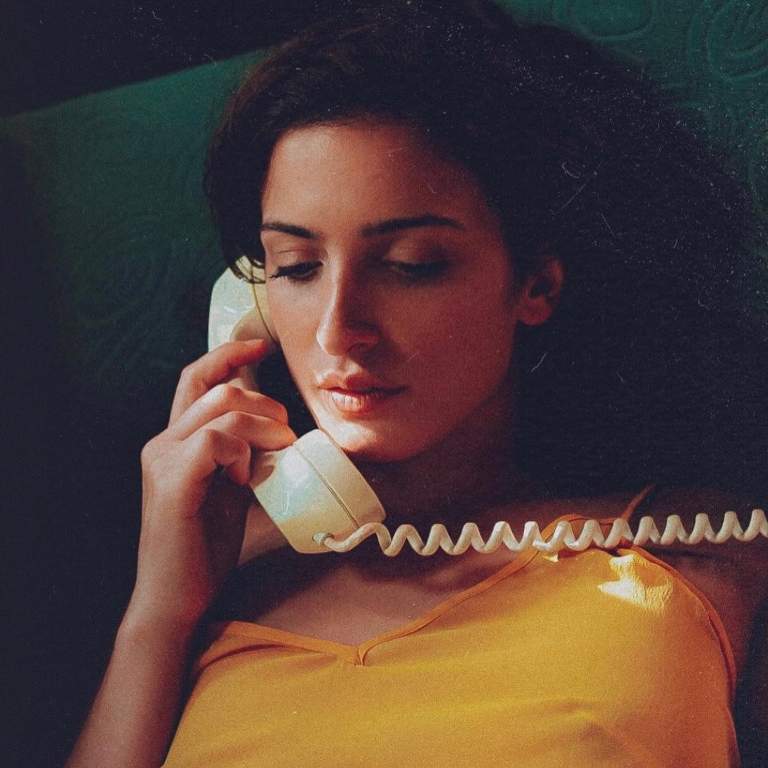 Samantha Scaffidi in a summer dress posing with a phone during her summer photoshoot for a picture