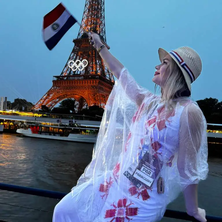 Luana Alonso in front of Eiffel tower with her Paraguayan flag.