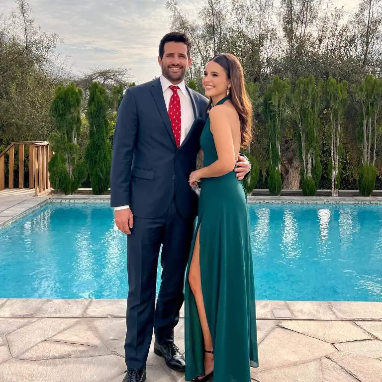 Stefano Peschiera's with his girlfriend, Paula Yábar posing in front of a swimming pool.