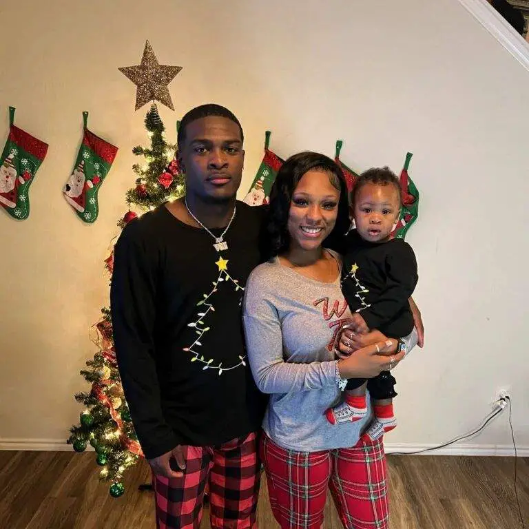 De'Von Achane and his baby mama and their son celebrating christmas and posing for a family picture