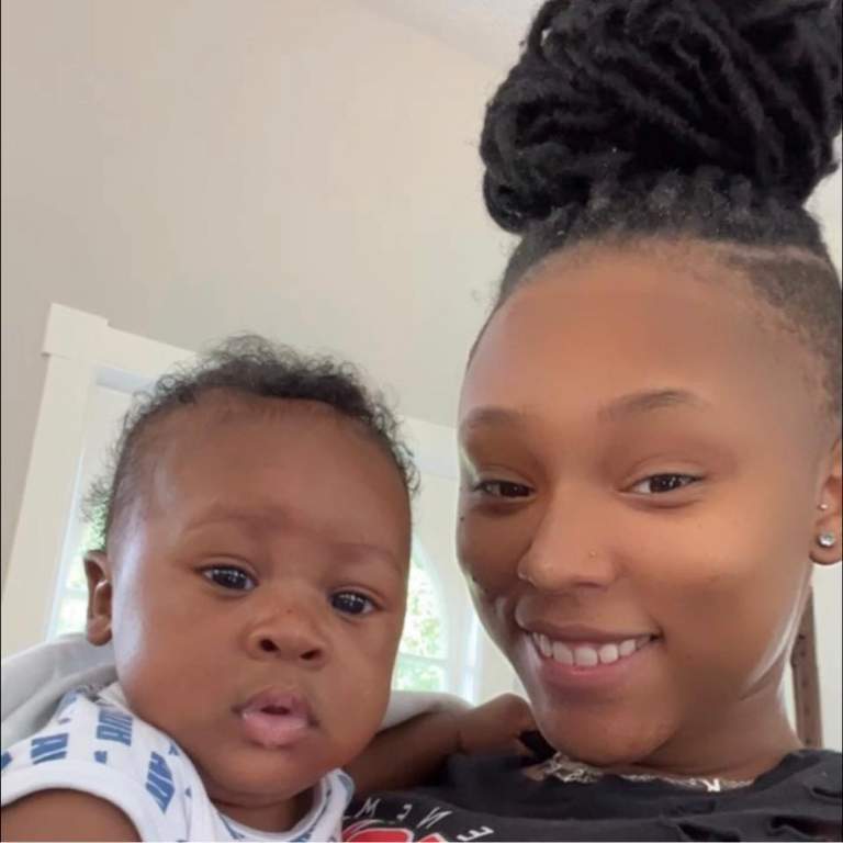 De'Von Achane’s baby mama posing for a selfie with their son in their home