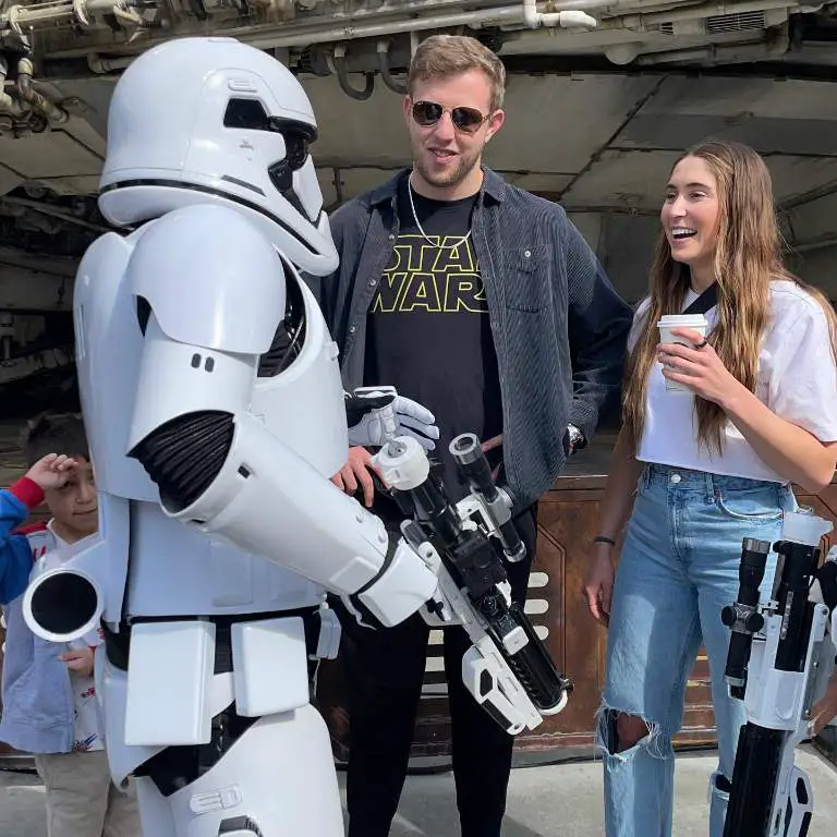 Nate Sudfeld and his Wife, Sierra Sudfeld posing for pictures while visiting Disneyland