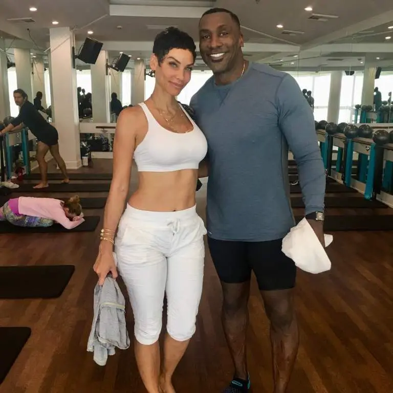 Shannon Sharpe with Nicole Murphy posing for picture post workout