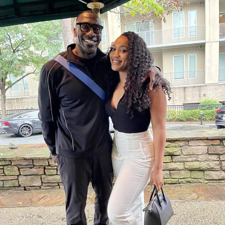 Shannon Sharpe posing for a picture with his eldest daughter while out for a lunch