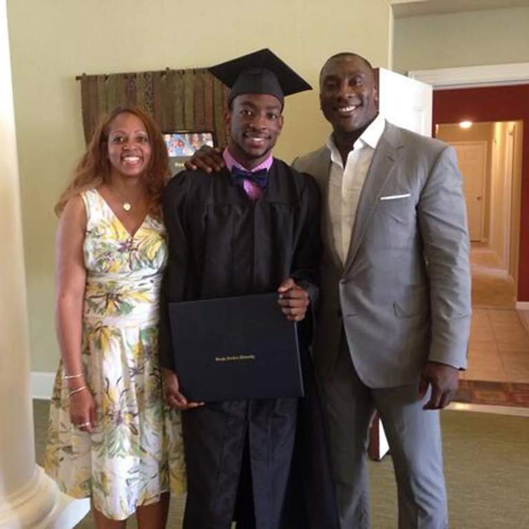 Shannon Sharpe posing for a picture with his only son and his ex-partner, Erika Evans